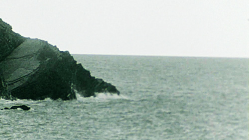 Thumbnail for Drowning in an Automated Sea - showing a moody view of the sea and a rock